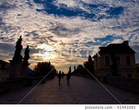 Prague sunset statue and Charles Bridge 81491085