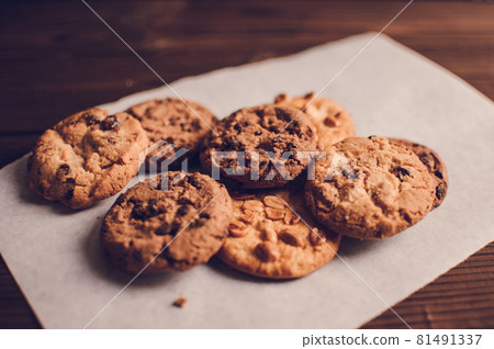 Chocolate cookies on wooden table. Chocolate chip cookies shot. Homemade food on wooden background 81491337