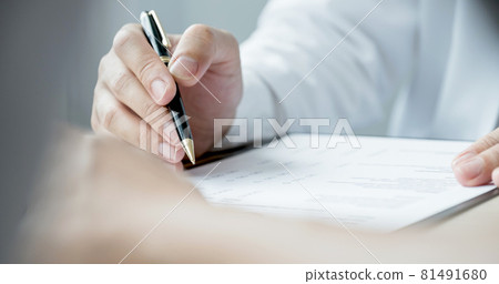 The doctor hand write report and explained the health examination results to the patient, medical checkup concept 81491680