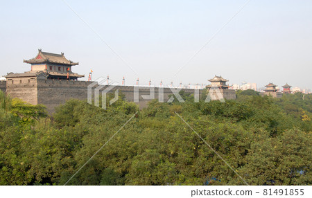 City Wall, Xian, Shaanxi Province, China. The City Wall of Xian is one of the largest and best preserved city fortifications in China. Watchtowers on Xian city wall overlooking trees. 81491855