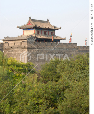 City Wall, Xian, Shaanxi Province, China. The City Wall of Xian is one of the largest and best preserved city fortifications in China. Watchtower on Xian city wall overlooking trees. 81491856