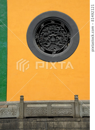Hangzhou, Zhejiang Province, China: Lingyin Temple also known as the Temple of the Soul's Retreat in Hangzhou, China. Architectural detail of a circular window at this ancient temple building. 81492121