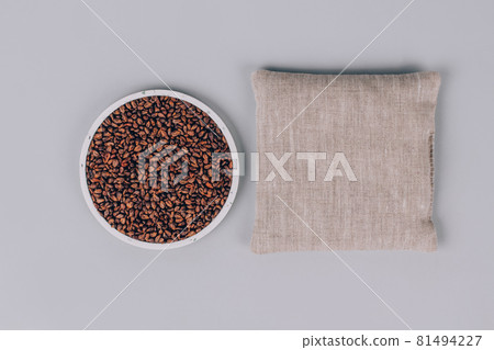 Grape seeds pillow, grape pits filled pillow for spa massage - natural heat or cool pack. Alternative medicine and therapy, pit sack for chiropractic care and home health. Copy space and mockup Grape seeds pillow, grape pits filled pillow for spa massage - natural heat or cool pack. Alternative medicine and therapy, pit sack for chiropractic care and home health. Copy space and mockup 81494227