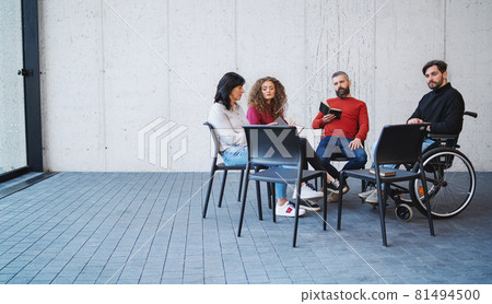 Sad men and women in wheelchair sitting in circle during group therapy, reading and talking. Sad men and women in wheelchair sitting in circle during group therapy, reading and talking. 81494500