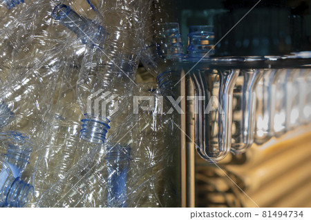 Abstract scene plastic bottle blowing machine and pile of PET bottles. Abstract scene plastic bottle blowing machine and pile of PET bottles. 81494734