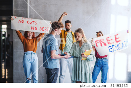 University students activists protesting indoors, fighting for free education concept. University students activists protesting indoors, fighting for free education concept. 81495385