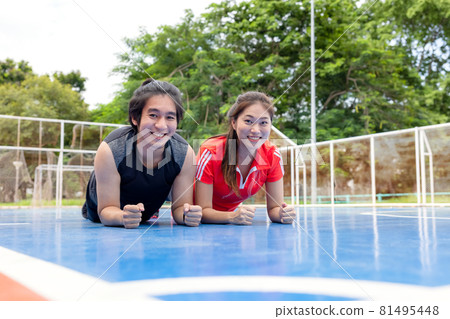 Woman and man sport couple doing stretching exercises working out outdoors Woman and man sport couple doing stretching exercises working out outdoors 81495448