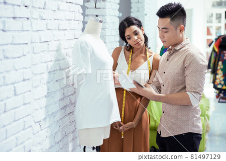 Seamstress and Fashion Designer Checking T-shir Seamstress and Fashion Designer Checking T-shir 81497129