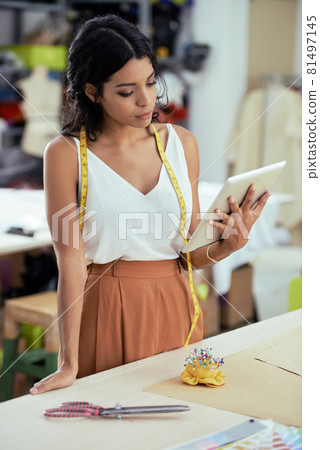 Seamstress with Tablet Computer Seamstress with Tablet Computer 81497145