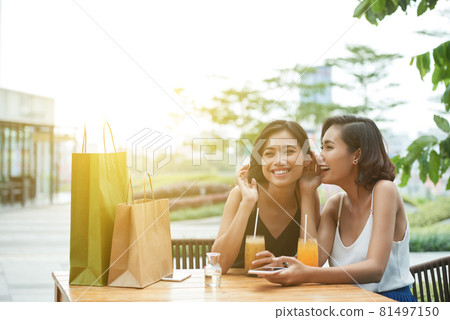 Woman Whispering Secret to Friend Woman Whispering Secret to Friend 81497150