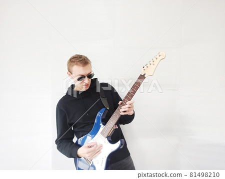 Foreign man playing electric guitar 81498210