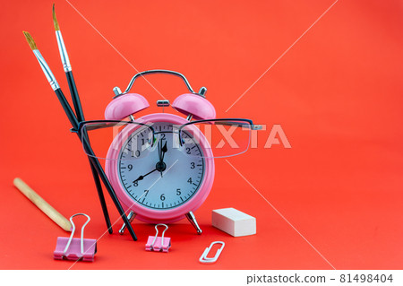 Concept Education or business Alarm clock and teacher glasses Business objects isolated on colorful background Back to school concept Concept Education or business Alarm clock and teacher glasses Business objects isolated on colorful background Back to school concept 81498404
