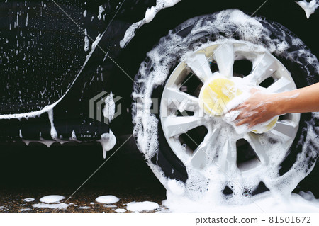 people man holding hand yellow sponge for washing car. cleaning wheel tire. Concept car wash clean. people man holding hand yellow sponge for washing car. cleaning wheel tire. Concept car wash clean. 81501672