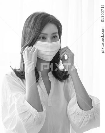 Young Asian woman wearing surgical mask at home to prevent coronavirus or flu infection in isolation Young Asian woman wearing surgical mask at home to prevent coronavirus or flu infection in isolation 81503712