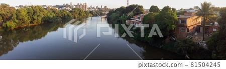 Mighty Paraiba do Sul river in Volta Redonda, Rio de Janeiro, Brazil. houses on the banks of the polluted river Mighty Paraiba do Sul river in Volta Redonda, Rio de Janeiro, Brazil. houses on the banks of the polluted river 81504245