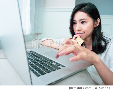Young Asian women use credit cards and laptops to shop online during the epidemic prevention period at home Young Asian women use credit cards and laptops to shop online during the epidemic prevention period at home 81504434