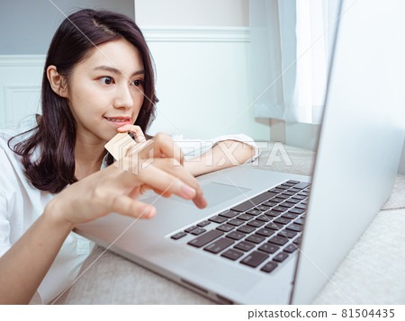 Young Asian women use credit cards and laptops to shop online during the epidemic prevention period at home Young Asian women use credit cards and laptops to shop online during the epidemic prevention period at home 81504435