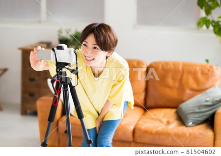A woman doing a pre-recording setup in front of the camera A woman doing a pre-recording setup in front of the camera 81504602