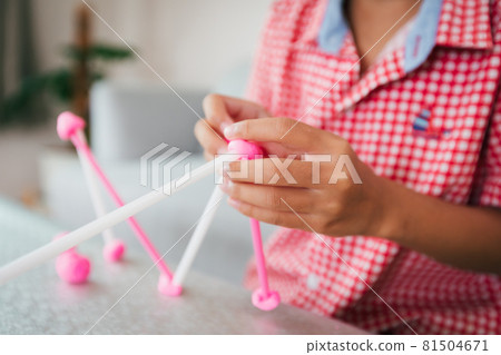 Cute asian child girl playing and creating with playdough and straws. Child concentrated with playdough building a molecule model. Kid and craft with recycle things. Cute asian child girl playing and creating with playdough and straws. Child concentrated with playdough building a molecule model. Kid and craft with recycle things. 81504671