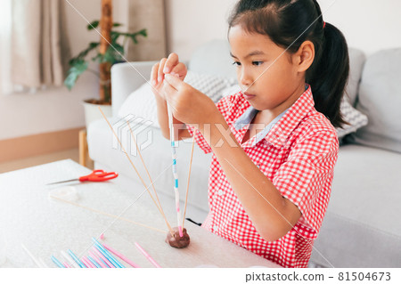 Cute asian child girl playing and creating with playdough and straws. Child concentrated with playdough building a molecule model. Kid and craft with recycle things. Cute asian child girl playing and creating with playdough and straws. Child concentrated with playdough building a molecule model. Kid and craft with recycle things. 81504673