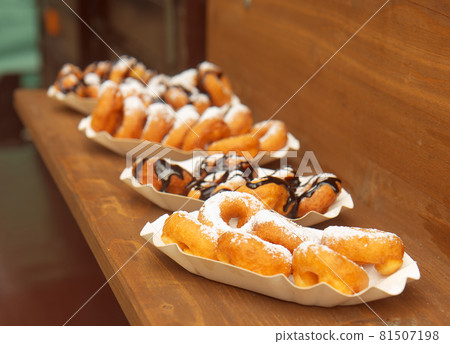 Selling mini donuts at Prague street food market. Mini donuts on offer at the farmers street food market in Karlin, Prague. Selling mini donuts at Prague street food market. Mini donuts on offer at the farmers street food market in Karlin, Prague. 81507198