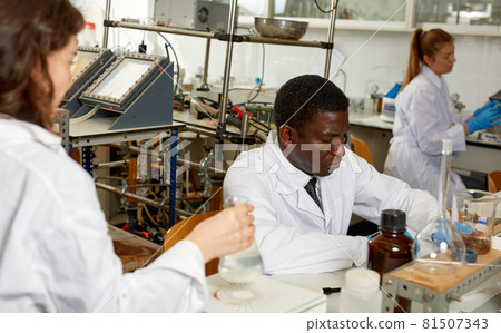 Focused lab technicians man writing report of chemical experiments Focused lab technicians man writing report of chemical experiments 81507343