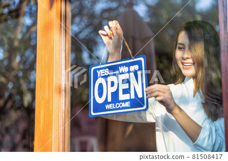 Asian young asian woman setting open sign at the shop glasses for welcome the customer in to the coffee shop, small business owner and startup with cafe shop, installing open and close label concept Asian young asian woman setting open sign at the shop glasses for welcome the customer in to the coffee shop, small business owner and startup with cafe shop, installing open and close label concept 81508417