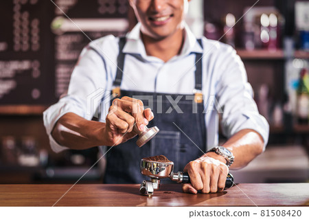 Asian Barista tamping the portafilter and preparing cup of coffee, espresso with latte or cappuccino for customer order in coffee shop, Small business owner and startup in coffee shop concept. Asian Barista tamping the portafilter and preparing cup of coffee, espresso with latte or cappuccino for customer order in coffee shop, Small business owner and startup in coffee shop concept. 81508420