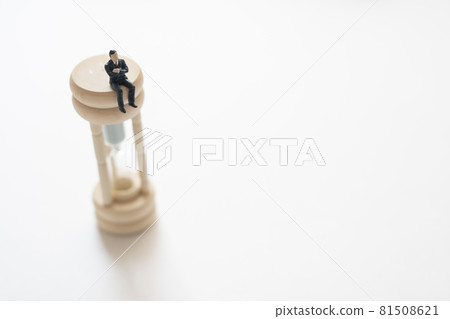 Office worker riding an hourglass (miniature) 81508621