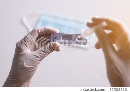 Patient women hands showing result a covid-19 self test rapid antigen testing at home Patient women hands showing result a covid-19 self test rapid antigen testing at home 81508810