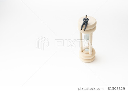 Office worker riding an hourglass (miniature) 81508829