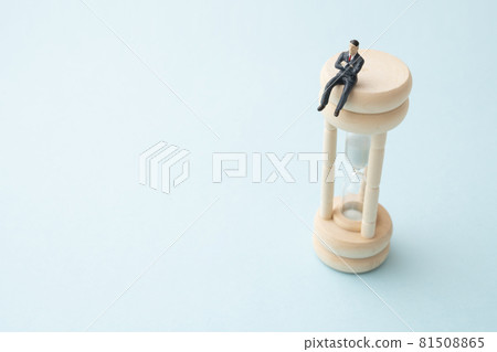 Office worker riding an hourglass (miniature) Office worker riding an hourglass (miniature) 81508865