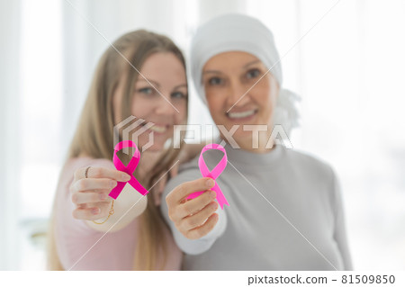 .Woman and female patient holding pink ribbon the symbol of breast cancer and smile for supported the cancer patient 81509850