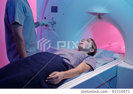Young woman on medical table moving into mri scan machine 81510972