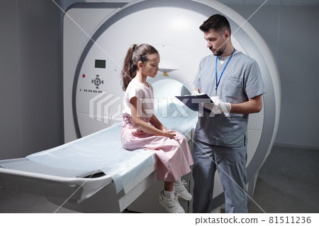 Serious radiologist making prescription to little girl Serious radiologist making prescription to little girl 81511236