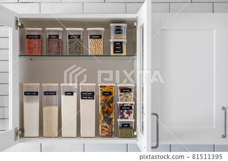 Kitchen storage organization use plastic case. Placing and sorting food products into pp box 81511395