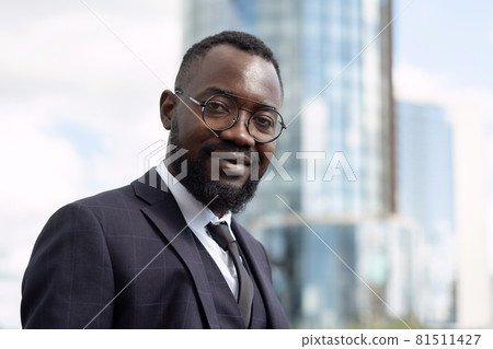 Happy young African businessman in formalwear looking at camera 81511427
