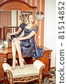 Beautiful young adult blond woman before the 81514852