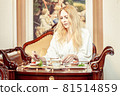 Beautiful young adult blond woman, On the table 81514859