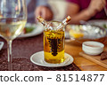 Glass on a high thin leg with white wine in a 81514877