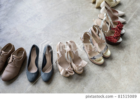 Top view many colored female shoes on gray floor footwear wheel fashion stylish footgear choosing 81515089