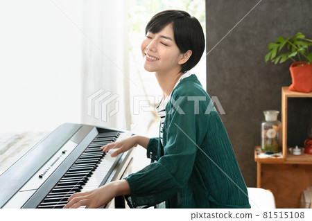 A woman playing the piano A woman playing the piano 81515108