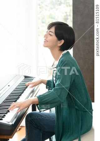 A woman playing the piano A woman playing the piano 81515109