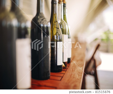 Wine bottles on wooden table 81515876