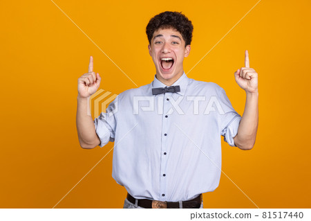 Asian man's portrait isolated over yellow studio background with copyspace for ad. Concept of human emotions, fashion, beauty, youth 81517440