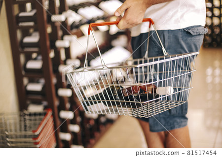 Crop man choosing wine in shop Crop man choosing wine in shop 81517454