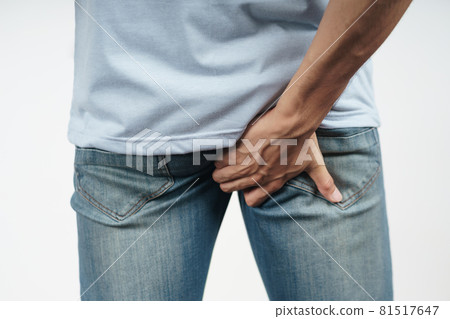 Young Man holding his bottom because Diarrhea, Hemorrhoids, constipation. Health care and medical concept. Young Man holding his bottom because Diarrhea, Hemorrhoids, constipation. Health care and medical concept. 81517647
