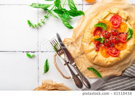 Fresh homemade galette with tomatoes, ricotta cheese and basil Fresh homemade galette with tomatoes, ricotta cheese and basil 81518438