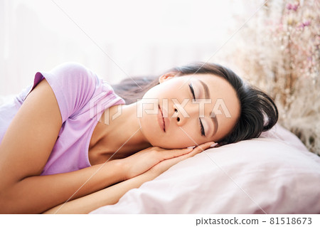 Pretty young woman sleeping in her bed and relaxing in the morning 81518673
