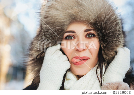 Playful female in outerwear showing tongue Playful female in outerwear showing tongue 81519068